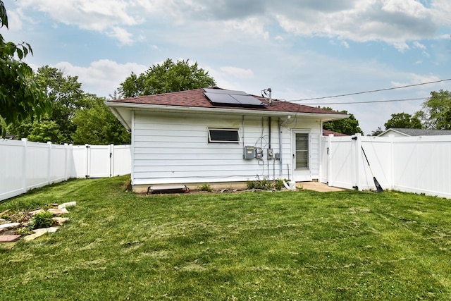 109 E Seminole St, Dwight, IL 60420 - back of house with a gate, solar panels, a fenced backyard, and a shingled roof