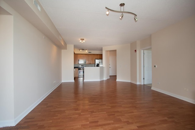 8440 Callie Ave Unit 410, Morton Grove, IL 60053 - unfurnished living room featuring wood finished floors and track lighting