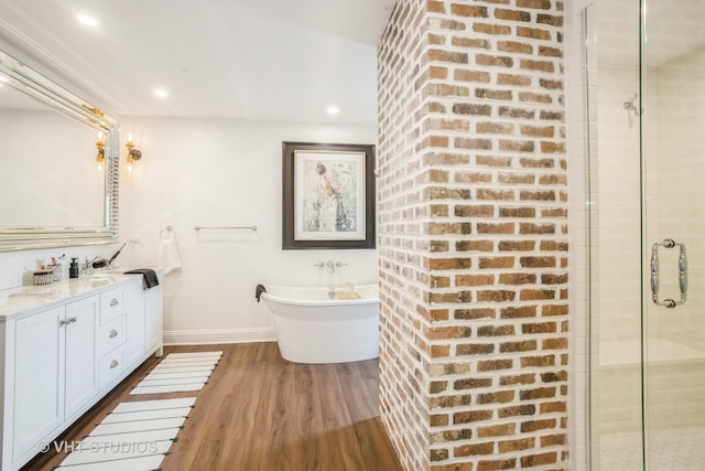 6140 Ruby St, Rosemont, IL 60018 - bathroom featuring vanity, a freestanding tub, a shower stall, wood finished floors, and recessed lighting