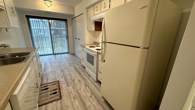 9530 Lamon Ave Unit 104, Skokie, IL 60077 - kitchen with white appliances, light wood-style flooring, white cabinetry, under cabinet range hood, and light countertops