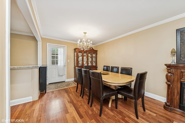 320 Pleasant St, Hoffman Estates, IL 60169 - dining space featuring a chandelier, wood finished floors, and ornamental molding