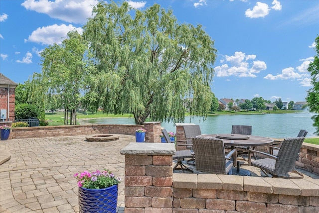 4905 Peifer Ln, Champaign, IL 61822 - view of patio featuring an outdoor fire pit, a water view, and outdoor dining space