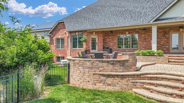 4905 Peifer Ln, Champaign, IL 61822 - back of house with brick siding, a shingled roof, and a chimney
