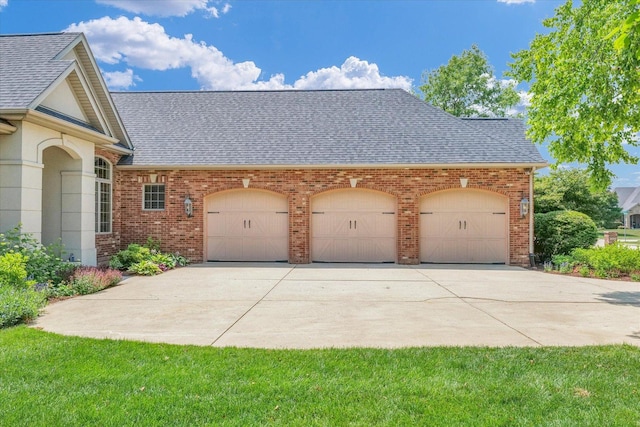 4905 Peifer Ln, Champaign, IL 61822 - view of side of property with roof with shingles, brick siding, a garage, and driveway