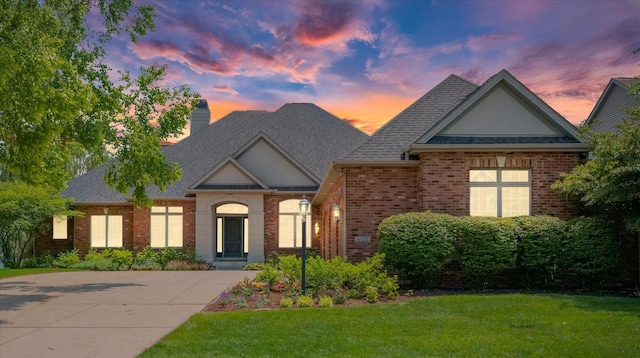 4905 Peifer Ln, Champaign, IL 61822 - view of front facade featuring brick siding, a yard, a chimney, and a shingled roof