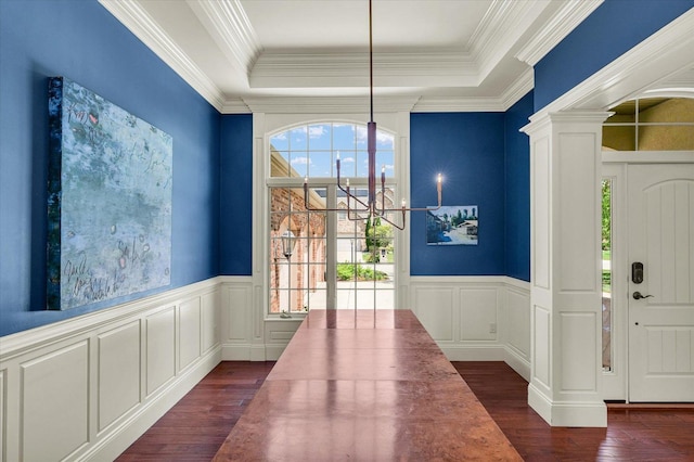 4905 Peifer Ln, Champaign, IL 61822 - unfurnished dining area with dark wood-style floors, a decorative wall, a chandelier, a wainscoted wall, and decorative columns