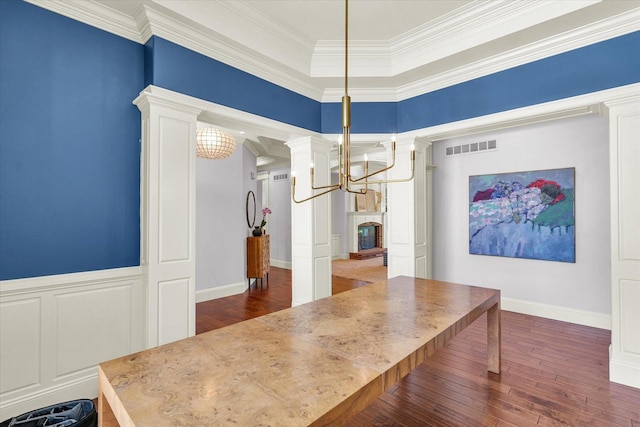 4905 Peifer Ln, Champaign, IL 61822 - dining area with a chandelier, dark wood-style floors, ornamental molding, and decorative columns