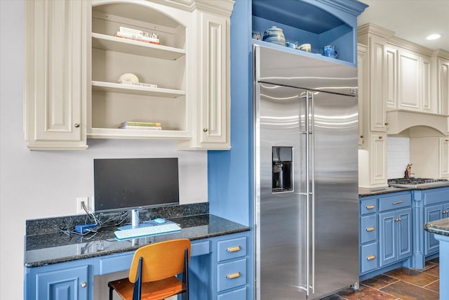 4905 Peifer Ln, Champaign, IL 61822 - kitchen featuring stainless steel appliances, blue cabinets, open shelves, dark stone counters, and backsplash