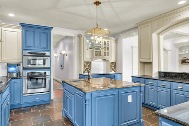 4905 Peifer Ln, Champaign, IL 61822 - kitchen featuring double oven, blue cabinetry, a kitchen island with sink, and recessed lighting