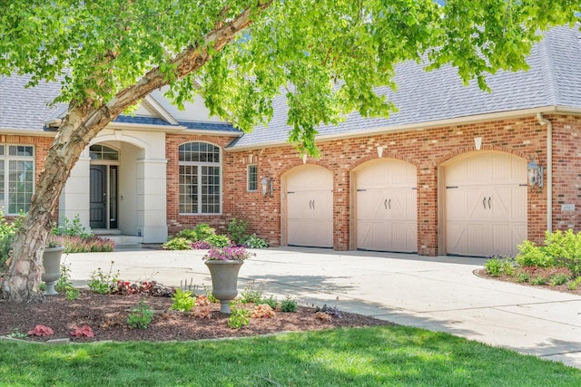 4905 Peifer Ln, Champaign, IL 61822 - view of front facade with driveway, roof with shingles, brick siding, and an attached garage