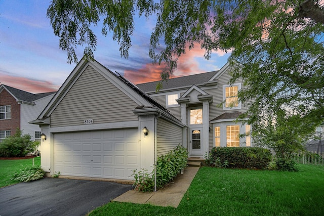 8304 Trumbull Ave, Joliet, IL 60431 - traditional-style house with driveway, a garage, and a lawn