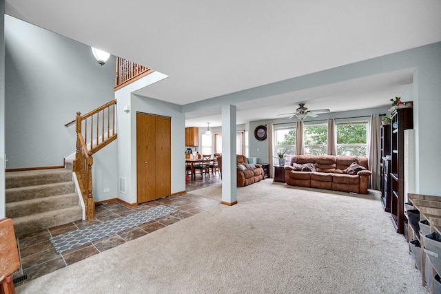8304 Trumbull Ave, Joliet, IL 60431 - living room featuring stairway, a ceiling fan, carpet floors, and stone finish floors