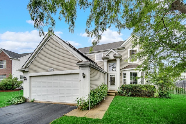 8304 Trumbull Ave, Joliet, IL 60431 - traditional home featuring an attached garage, driveway, and a front yard