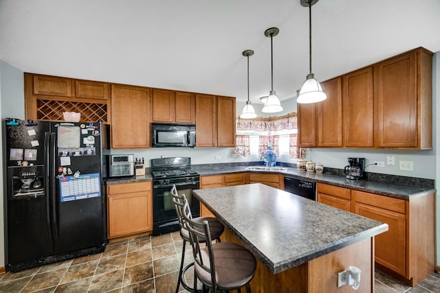 8304 Trumbull Ave, Joliet, IL 60431 - kitchen featuring black appliances, dark countertops, brown cabinets, a center island, and a kitchen breakfast bar
