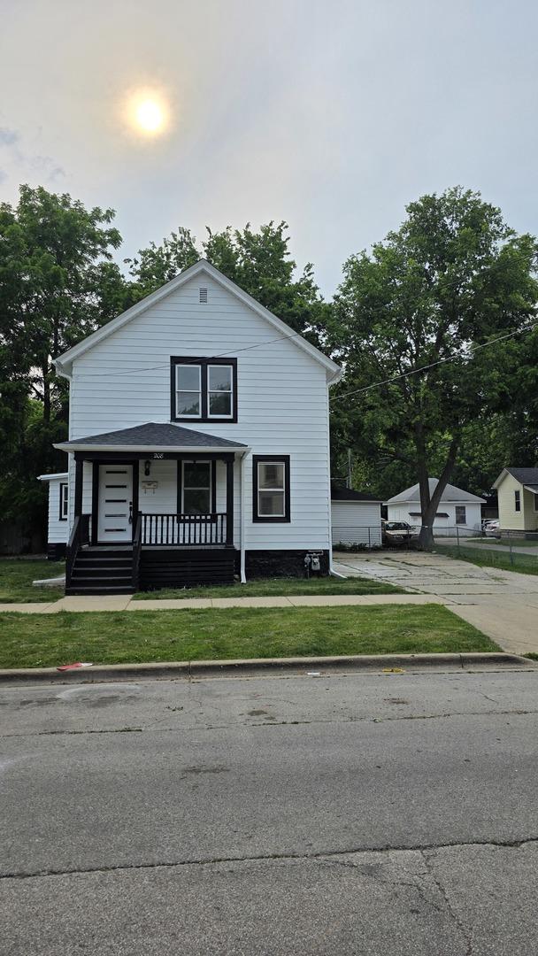 208 N Chestnut St, Aurora, IL 60506 - bungalow with covered porch and a front lawn