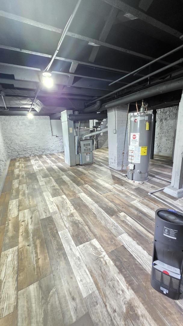 208 N Chestnut St, Aurora, IL 60506 - unfinished basement with gas water heater and wood-type flooring
