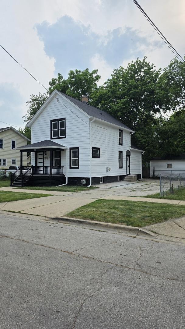 208 N Chestnut St, Aurora, IL 60506 - view of front of property featuring a porch, a front yard, and a chimney