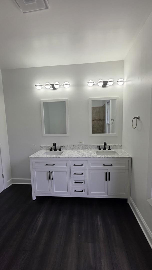 208 N Chestnut St, Aurora, IL 60506 - full bathroom with wood finished floors and double vanity