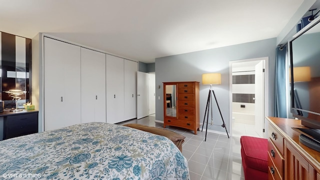 5050 S E End Ave Unit 9C, Chicago, IL 60615 - tiled bedroom featuring a closet and ensuite bathroom