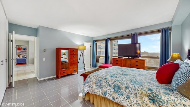 5050 S E End Ave Unit 9C, Chicago, IL 60615 - tiled bedroom featuring baseboards