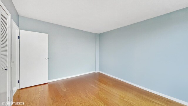 5050 S E End Ave Unit 9C, Chicago, IL 60615 - unfurnished bedroom with light wood finished floors and a closet