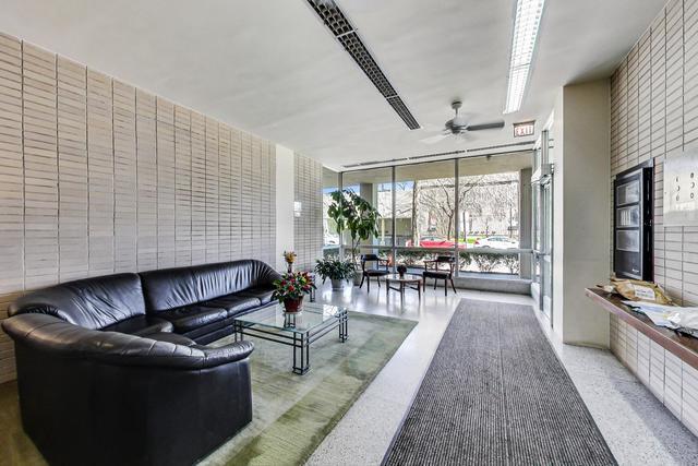 5050 S E End Ave Unit 9C, Chicago, IL 60615 - living area with expansive windows and a ceiling fan