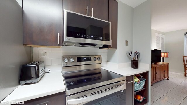 5050 S E End Ave Unit 9C, Chicago, IL 60615 - kitchen with stainless steel appliances, dark brown cabinetry, light countertops, and light tile patterned floors