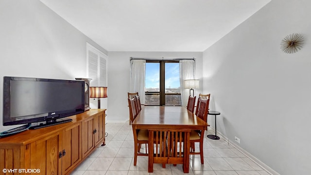 5050 S E End Ave Unit 9C, Chicago, IL 60615 - dining space featuring baseboards and light tile patterned flooring