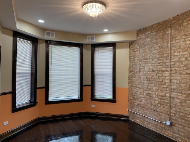 1826 S Drake Ave, Chicago, IL 60623 - unfurnished room with hardwood / wood-style flooring, recessed lighting, and brick wall