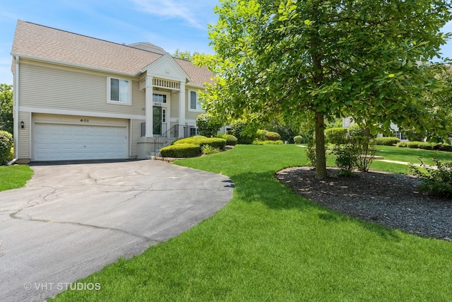 601 Cary Woods Cir Unit 601, Cary, IL 60013 - bi-level home with driveway, a shingled roof, a front lawn, and an attached garage