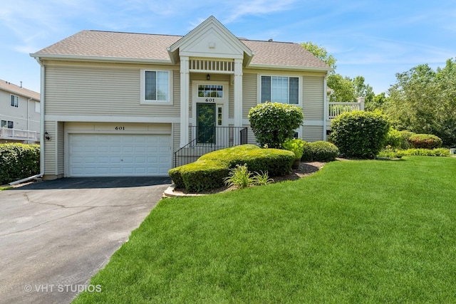 601 Cary Woods Cir Unit 601, Cary, IL 60013 - view of front facade featuring asphalt driveway, a front yard, a garage, and roof with shingles