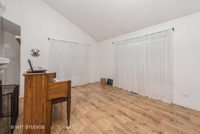 601 Cary Woods Cir Unit 601, Cary, IL 60013 - unfurnished room featuring high vaulted ceiling, wood finished floors, and a fireplace