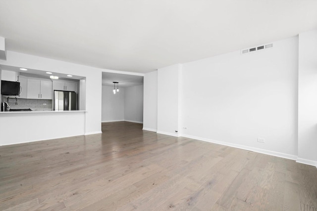 7234 W N Ave Unit 1806, Elmwood Park, IL 60707 - unfurnished living room featuring wood finished floors and baseboards