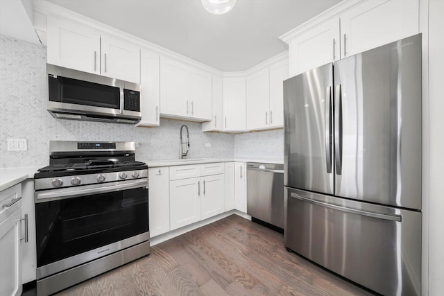 7234 W N Ave Unit 1806, Elmwood Park, IL 60707 - kitchen with stainless steel appliances, light countertops, dark wood-style floors, white cabinetry, and backsplash