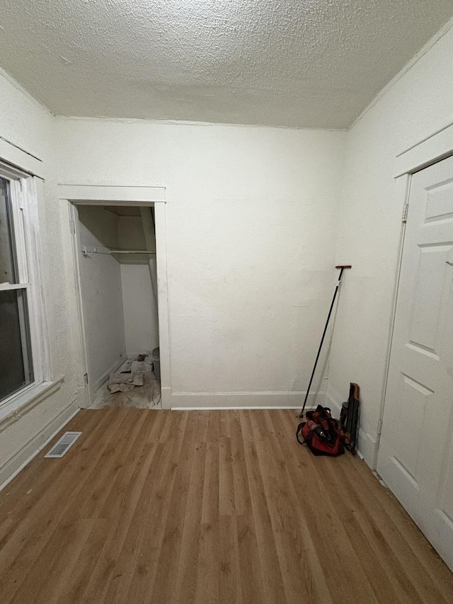 5604 S Morgan St, Chicago, IL 60621 - unfurnished bedroom with wood finished floors and a textured ceiling