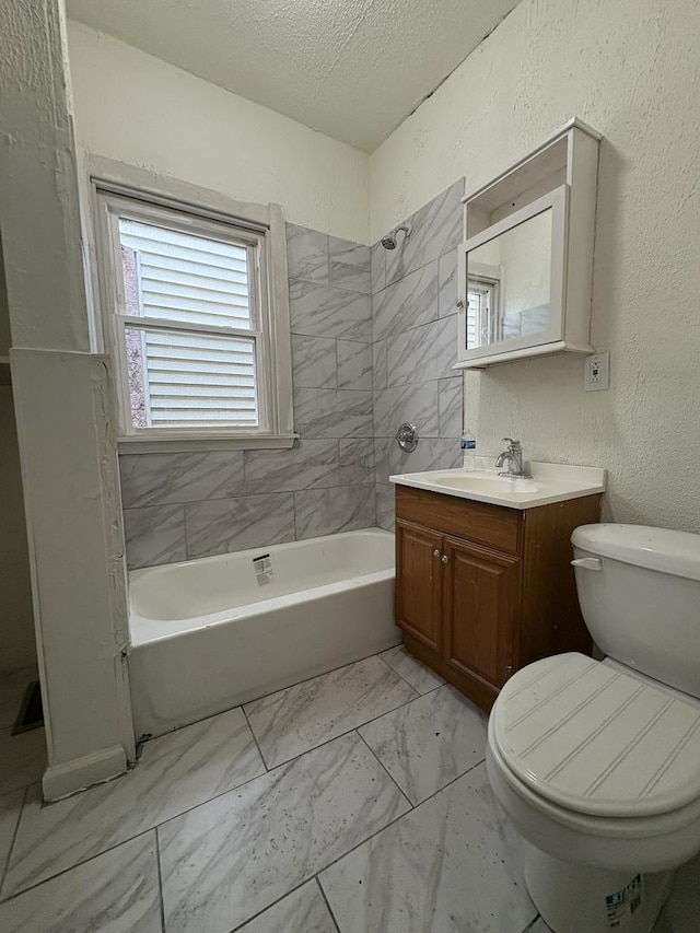 5604 S Morgan St, Chicago, IL 60621 - bathroom featuring vanity, a textured ceiling, marble look tile flooring, and  shower combination