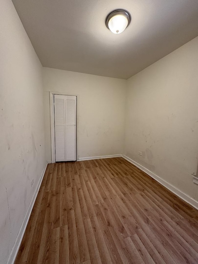 5604 S Morgan St, Chicago, IL 60621 - unfurnished bedroom with wood finished floors and a closet