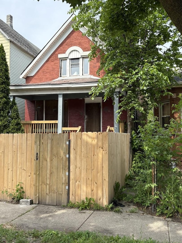 5604 S Morgan St, Chicago, IL 60621 - view of front of property featuring brick siding, a fenced front yard, and covered porch