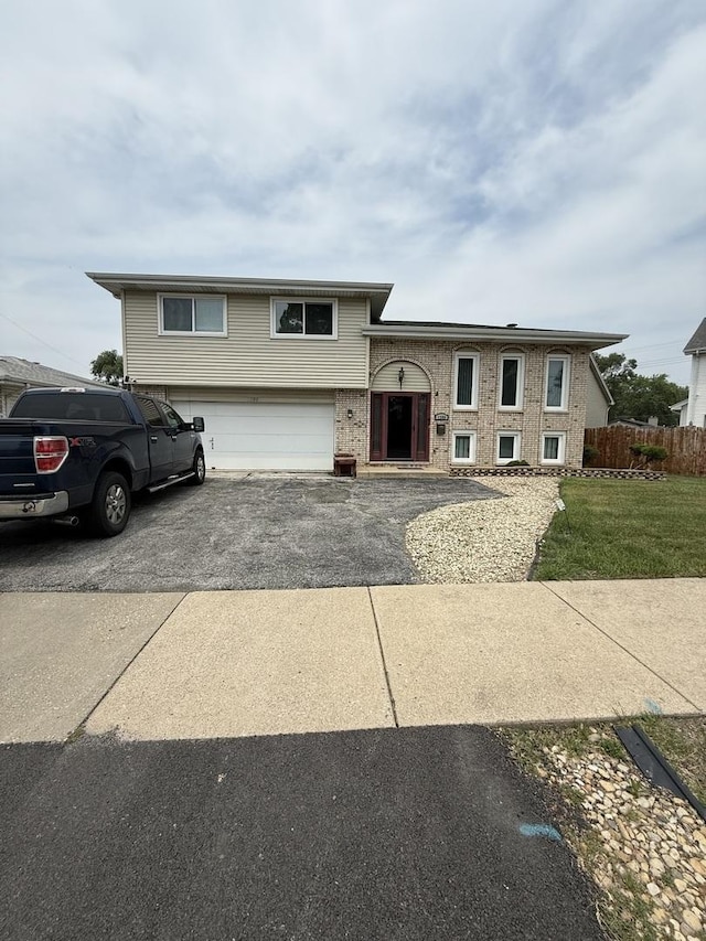 1208 E 154th St, South Holland, IL 60473 - view of front facade with an attached garage and asphalt driveway