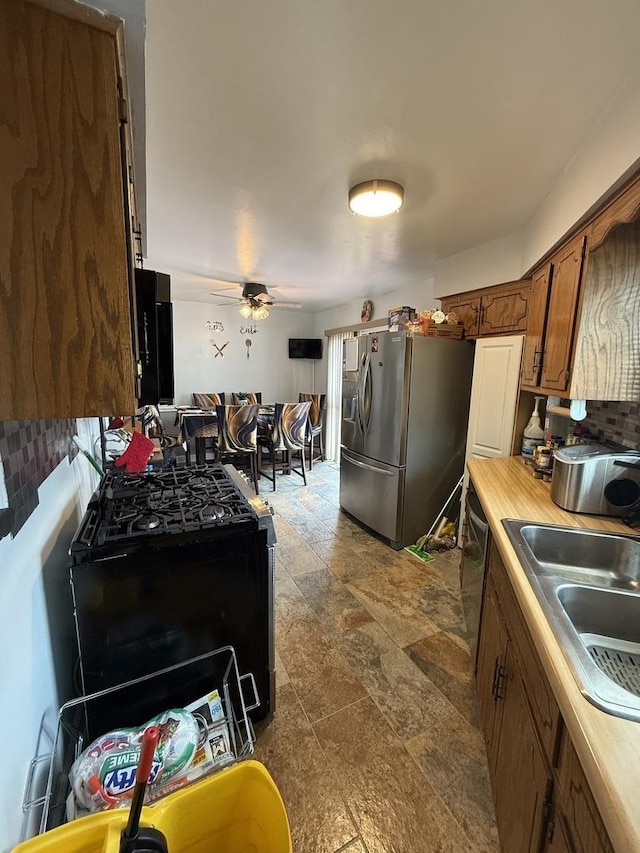 1208 E 154th St, South Holland, IL 60473 - kitchen with appliances with stainless steel finishes, decorative backsplash, dark stone finish flooring, and ceiling fan