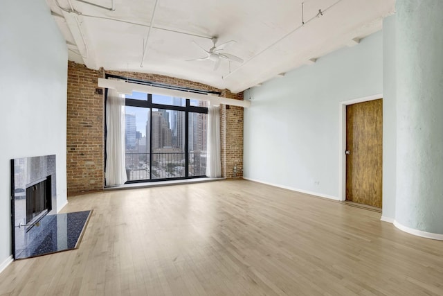 1322 S Wabash Ave Unit 807, Chicago, IL 60605 - unfurnished living room with a ceiling fan, wood finished floors, a fireplace, and brick wall