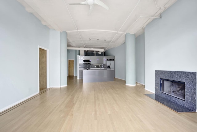 1322 S Wabash Ave Unit 807, Chicago, IL 60605 - unfurnished living room featuring light wood-style flooring, a fireplace, and a ceiling fan