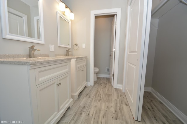 816 Blackhawk Dr, University Park, IL 60484 - bathroom with wood finished floors and double vanity