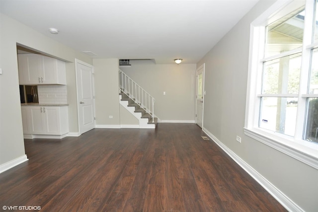 816 Blackhawk Dr, University Park, IL 60484 - unfurnished living room featuring stairs and dark wood-style floors