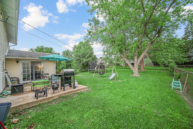 816 Blackhawk Dr, University Park, IL 60484 - fenced backyard featuring a trampoline, a patio area, and a playground
