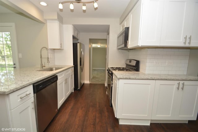 816 Blackhawk Dr, University Park, IL 60484 - kitchen with stainless steel appliances, a peninsula, tasteful backsplash, white cabinets, and light stone counters