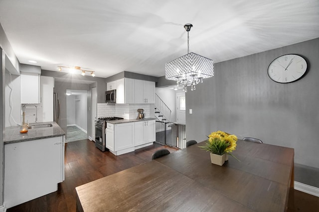 816 Blackhawk Dr, University Park, IL 60484 - dining room featuring a chandelier, stairs, and dark wood finished floors