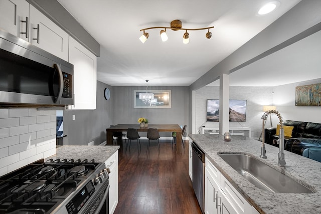 816 Blackhawk Dr, University Park, IL 60484 - kitchen featuring appliances with stainless steel finishes, light stone counters, backsplash, white cabinetry, and dark wood-style flooring