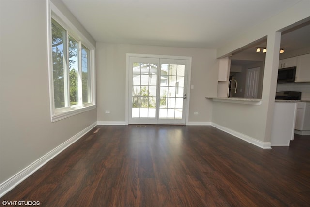 816 Blackhawk Dr, University Park, IL 60484 - unfurnished living room featuring dark wood-style flooring and baseboards