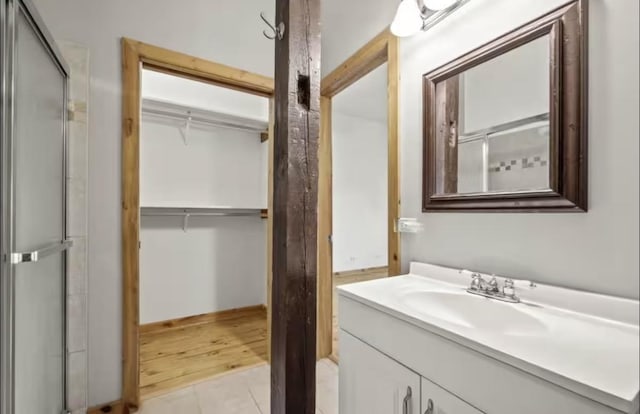 9439 Corneils Rd, Bristol, IL 60512 - bathroom featuring vanity, a spacious closet, and an enclosed shower